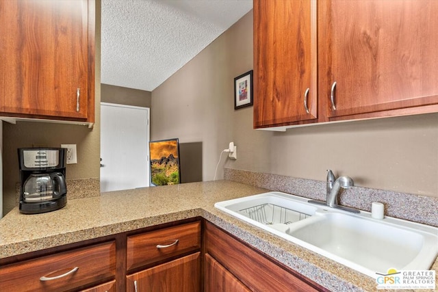 kitchen with sink and a textured ceiling