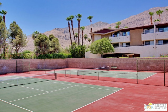 view of tennis court featuring a mountain view