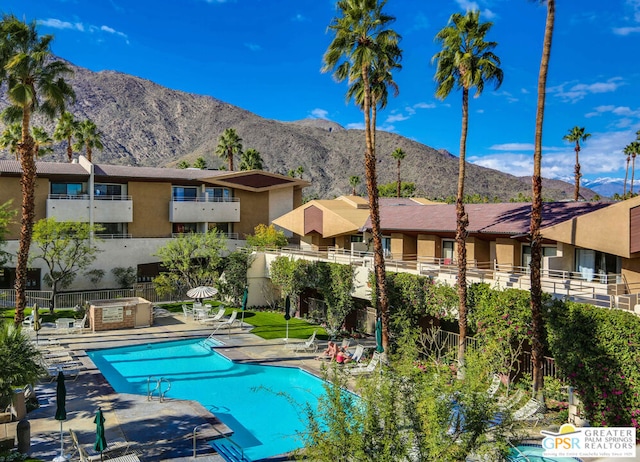 view of pool featuring a mountain view and a patio