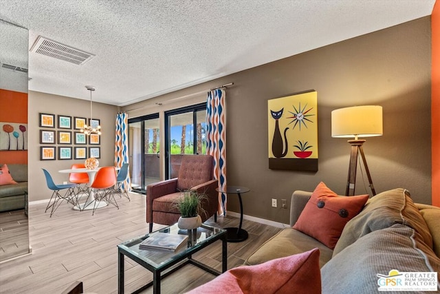 living room featuring a textured ceiling and light wood-type flooring