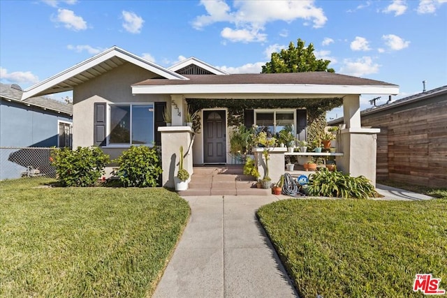 view of front of property with a porch and a front lawn