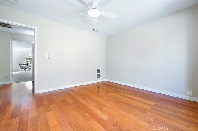 empty room featuring hardwood / wood-style floors and ceiling fan