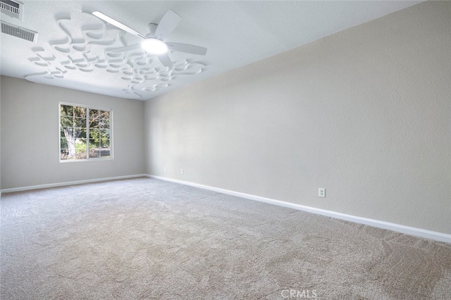 spare room featuring ceiling fan and carpet floors