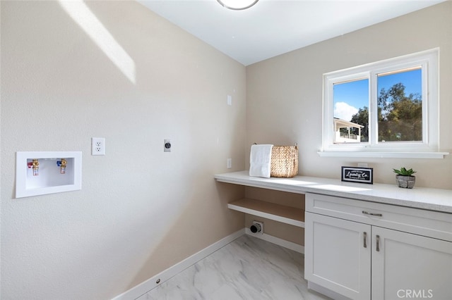 laundry room with hookup for an electric dryer, washer hookup, and cabinets