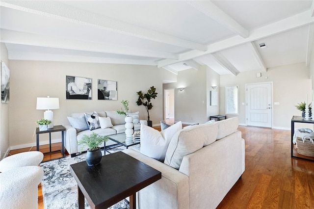 living room featuring lofted ceiling with beams and dark hardwood / wood-style floors