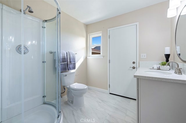 bathroom featuring a shower with door, toilet, and vanity