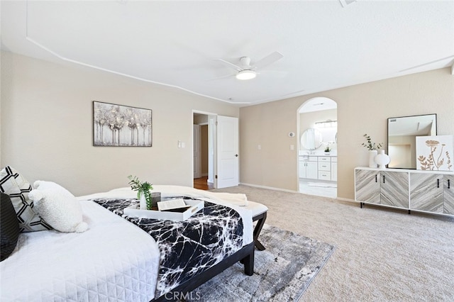 bedroom featuring connected bathroom, carpet, and ceiling fan