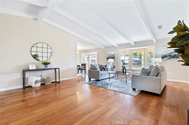 living room with hardwood / wood-style flooring and lofted ceiling with beams