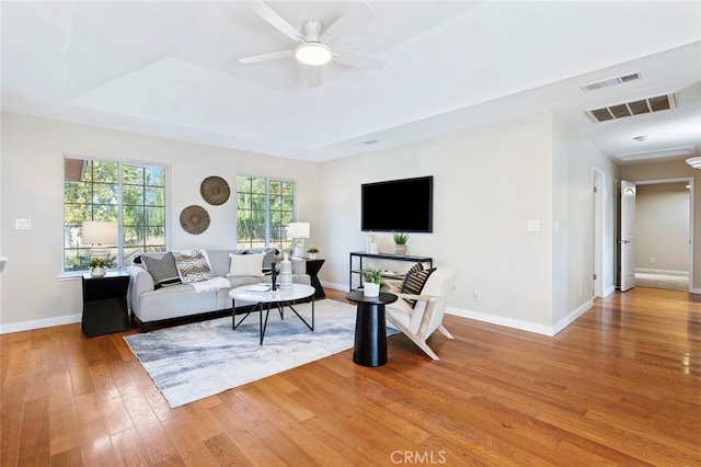 living room featuring ceiling fan and hardwood / wood-style floors