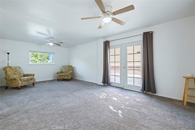 unfurnished room with a wealth of natural light, french doors, carpet floors, and ceiling fan