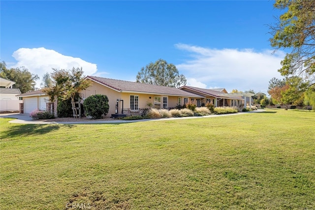 ranch-style home with a front yard and a garage