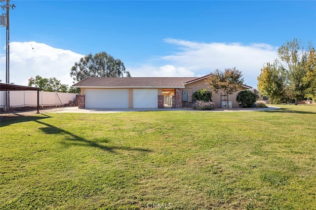 ranch-style house featuring a front yard and a garage