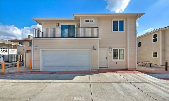 view of front of house with a garage and a balcony