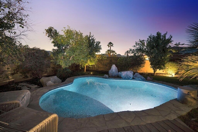 view of pool at dusk