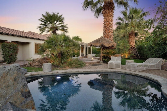 view of pool at dusk