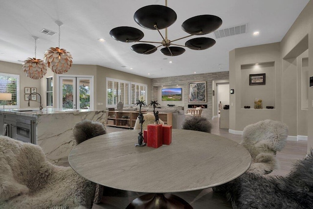 dining room featuring sink and light hardwood / wood-style flooring