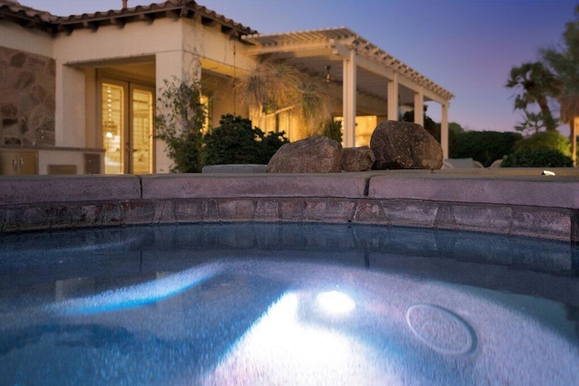 view of pool at dusk