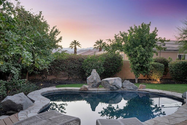 view of pool at dusk