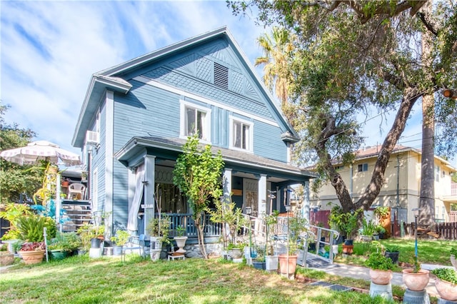 view of front of home featuring a front yard and a porch