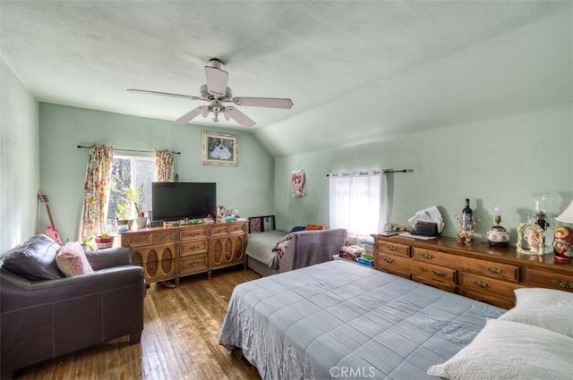 bedroom with a textured ceiling, vaulted ceiling, dark hardwood / wood-style floors, and ceiling fan