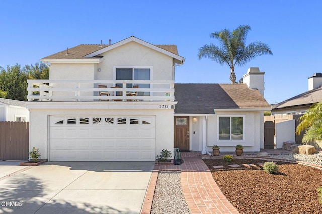 front of property with a balcony and a garage