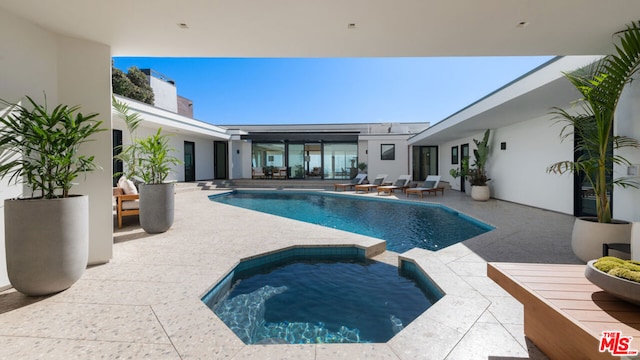 view of swimming pool featuring an in ground hot tub and a patio