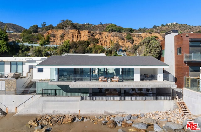 rear view of house featuring a mountain view