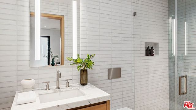 bathroom featuring vanity and an enclosed shower