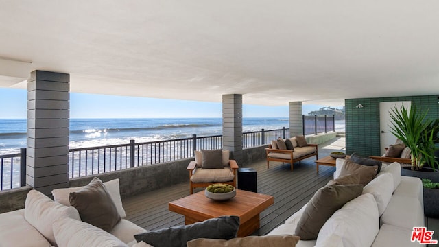 exterior space featuring a view of the beach, an outdoor living space, and a water view