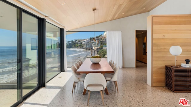 dining room featuring lofted ceiling, a water view, and wooden ceiling