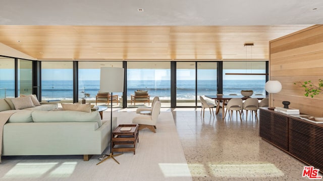 living room with expansive windows, a water view, and wood ceiling