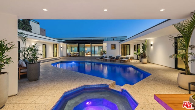 view of pool featuring an in ground hot tub and a patio