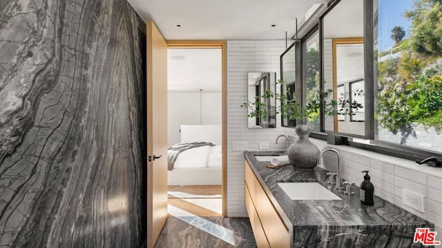 bathroom featuring vanity and tasteful backsplash