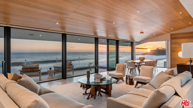 living room featuring a water view, wooden ceiling, vaulted ceiling, and a view of the beach