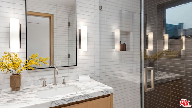 bathroom featuring vanity and tile walls