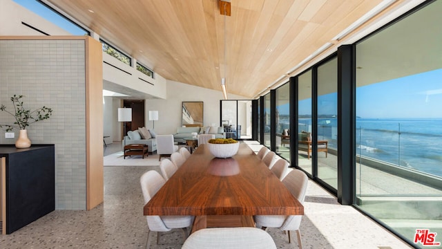 dining room with a water view, vaulted ceiling, plenty of natural light, and wood ceiling