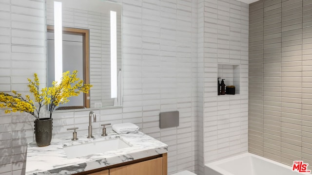 bathroom featuring vanity and a bath