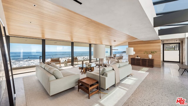 living room with a beach view, a water view, lofted ceiling, and wood ceiling