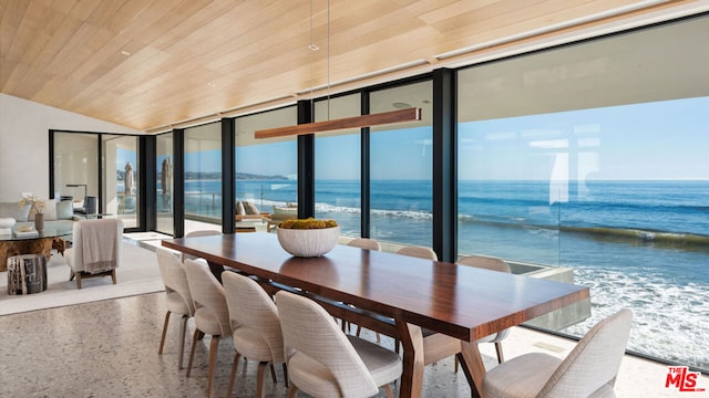 dining space with expansive windows, a water view, and wood ceiling