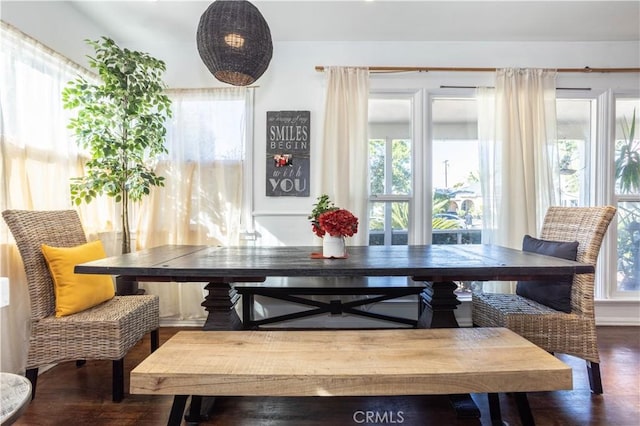 dining area with breakfast area and dark wood-type flooring