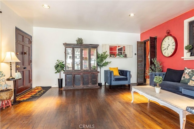 living room with dark hardwood / wood-style flooring