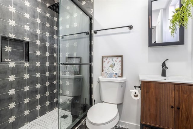 bathroom with vanity, toilet, and a shower with shower door