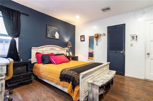 bedroom with dark hardwood / wood-style flooring