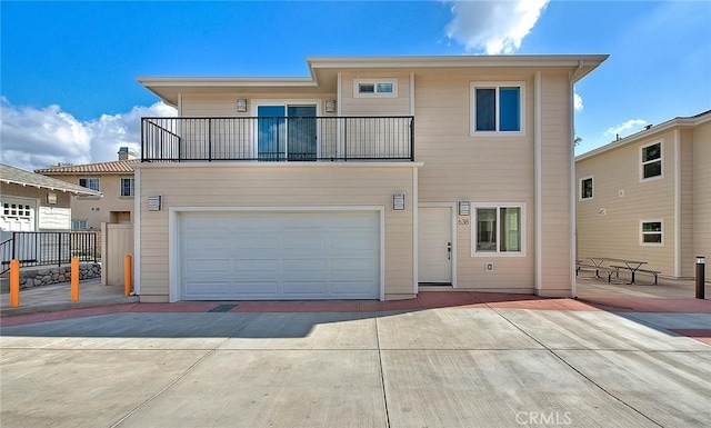 view of front of property with a garage and a balcony