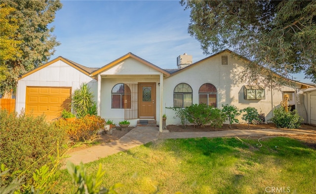 view of front of property with a front yard and a garage