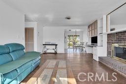 living room featuring a fireplace and dark hardwood / wood-style floors