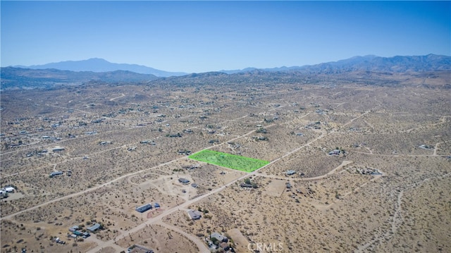 birds eye view of property featuring a mountain view