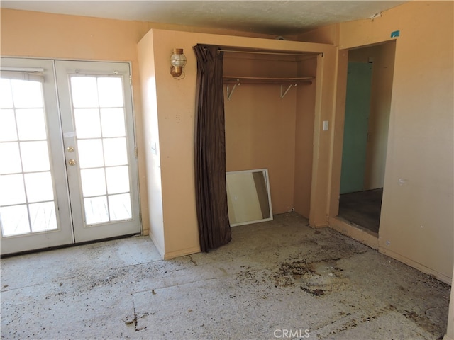 unfurnished bedroom with french doors