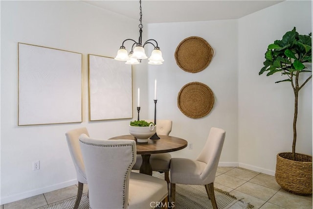 dining area with light tile patterned floors and an inviting chandelier