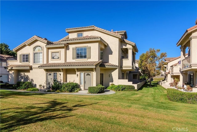 mediterranean / spanish-style house with a front yard